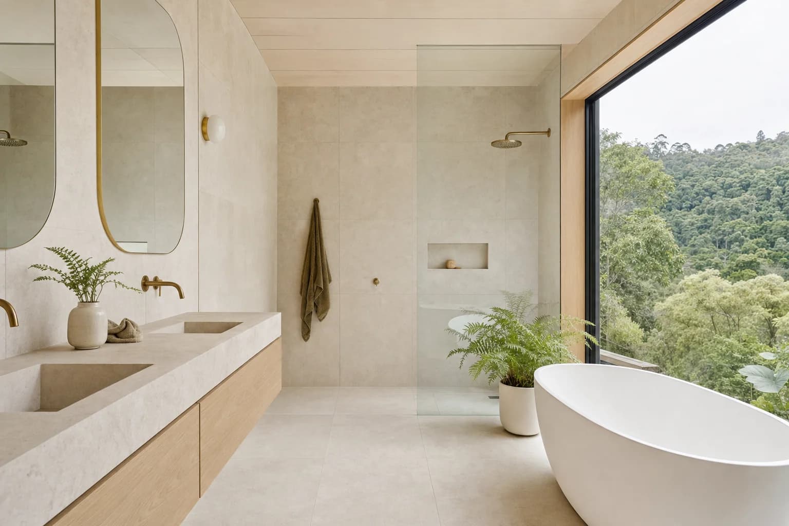 Renovated bathroom in a Currumbin Valley timber home with limestone tiling, a wall-hung oak vanity and a large window looking out to rainforest hills